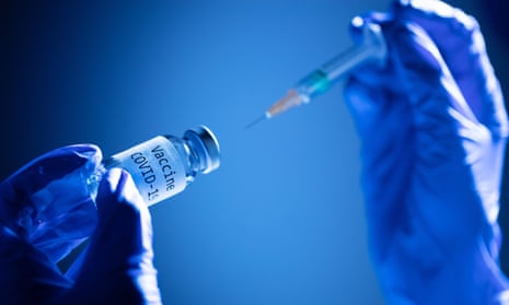 a syringe and a bottle reading “Vaccine Covid-19”