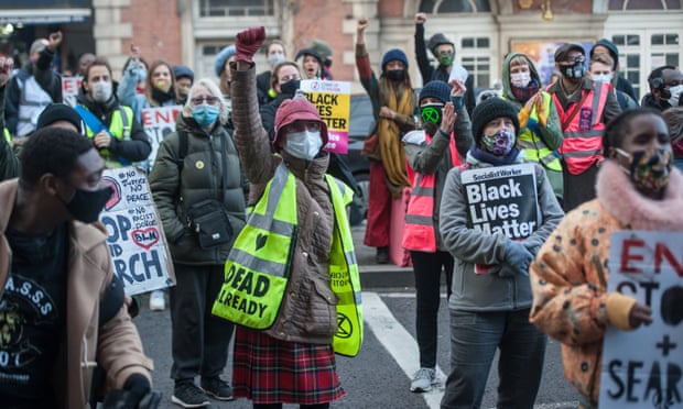 Activists and community groups block a road outside Tottenham police station in London in December 2020 in protest at targeting of black youth by officers.