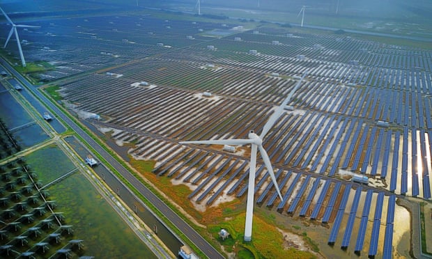 Aerial view of an industrial base consisting of wind turbines, solar panels and fish ponds at tidal flats on July 25, 2017 in Yancheng, Jiangsu Province of China. 
