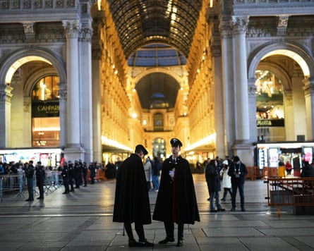 Italian police patrol near Milan Cathedral before the arrival of the torchbearer carrying the Olympic torch flame