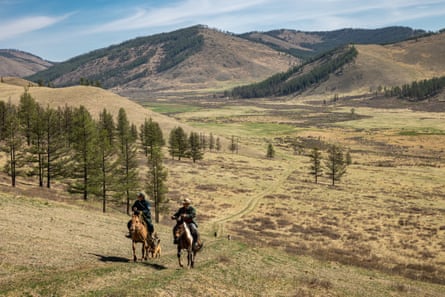 Two people riding on horseback