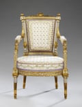 An armchair of carved walnut, late 1780s.