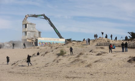 People look at the Signal building on the last day of its demolition in Soulac-sur-Mer.