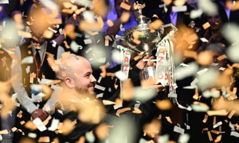 Luca Brecel celebrates with the trophy after winning against Mark Selby the World Championship Snooker final match at The Crucible in Sheffield.
