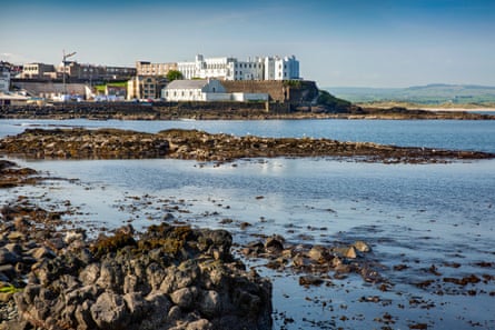 Rocky shore with buildings behind