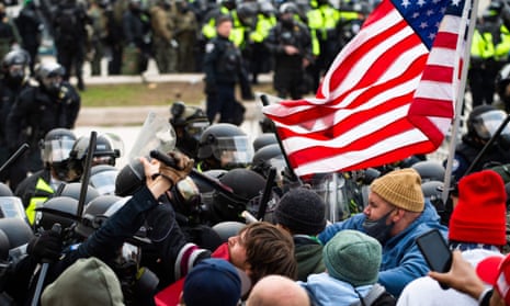 Trump supporters fight with riot police outside the Capitol building on 6 January. 