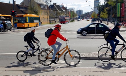 Child cycles with adult in Copenhagen