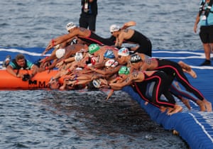 Athletes dive into the water