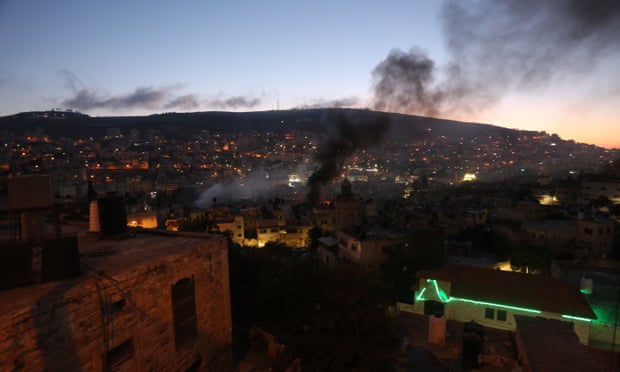 Smoke rises during the clash at a house in Nablus, in the West Bank