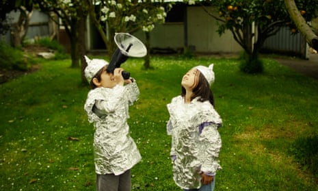 Children wear protective baking foil whilst watching out for possible alien invasion.