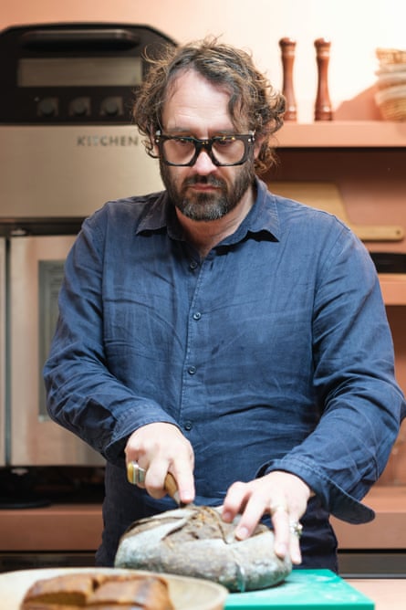 Richard Hart slices a round loaf