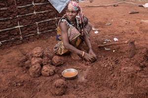 At a camp for displaced people outside Negomano village near the Tanzanian border, Nura makes mud bricks to build houses