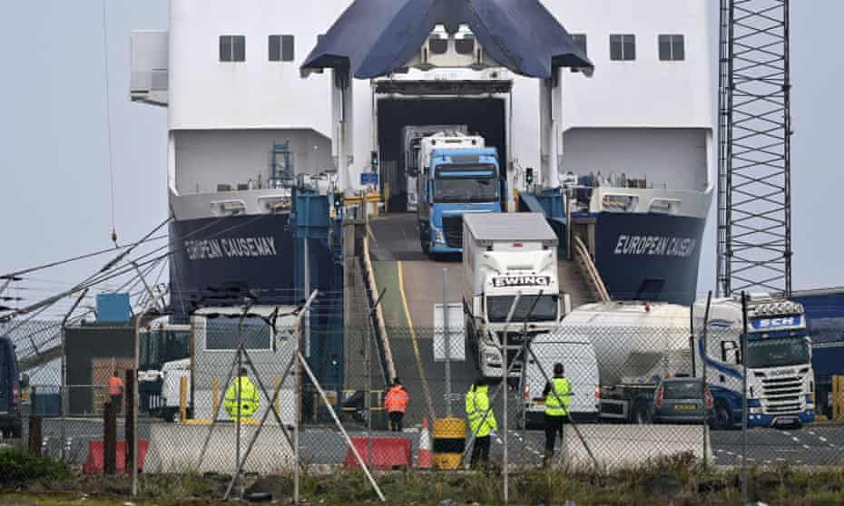 Customs and border officials watch as freight disembarks at Larne harbour.