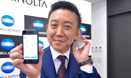 Daisuke Koda, from Konica Minolta, demonstrates the use of the Kunkun body odour checker behind the ear. The results show up on a smartphone app via Bluetooth.