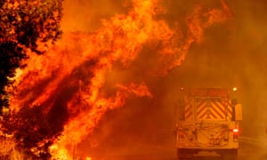 A fire truck drives through flames as the Hennessey fire continues to rage out of control near Lake Berryessa in Napa, California.