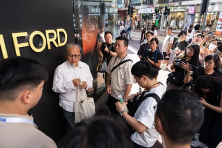 Plainclothes police officers stop and search the artist Sanmu Chen