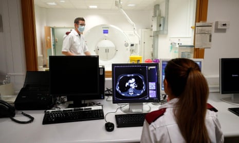 Medical staff prepare to receive a patient for a CT Scan