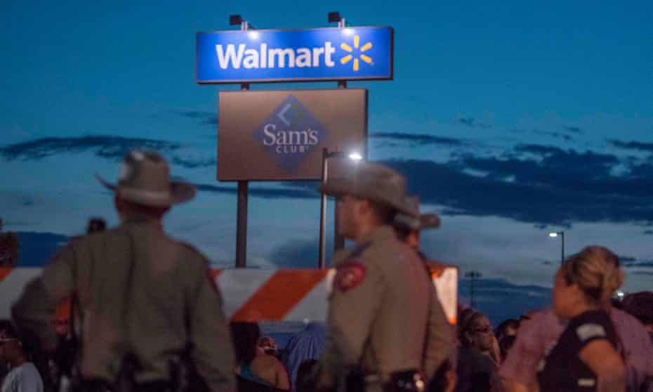Texas state troopers keep watch at the makeshift memorial for victims of the mass shooting at a Walmart in El Paso. The retailer subsequently announced it would stop selling ammunition for assault rifles.