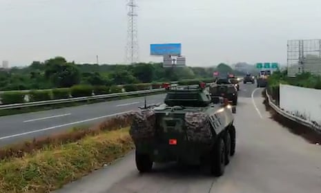 China releases video showing troop carriers moving to Hong Kong border