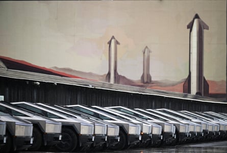 row of parked cybertrucks outside building
