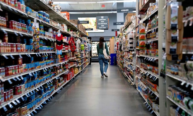 A shopper walks through a grocery store in Washington DC.