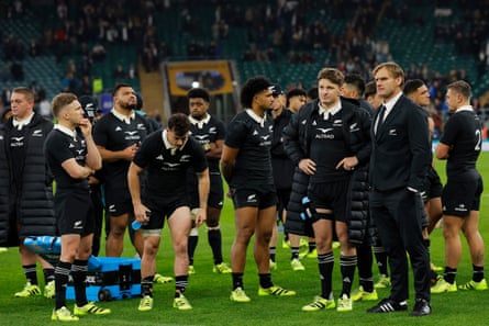 The New Zealand head coach, Scott Robertson, and his charges, including Beauden Barrett, look dejected after their defeat by England.
