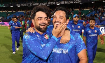 Rashid Khan and Gulbadin Naib celebrate after Afghanistan’s victory.