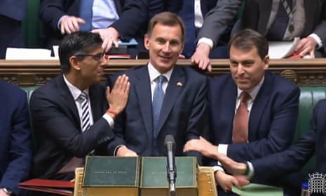 Rishi Sunak (L) congratulating Jeremy Hunt (C) after he delivered his autumn statement to MPs in the House of Commons in November.