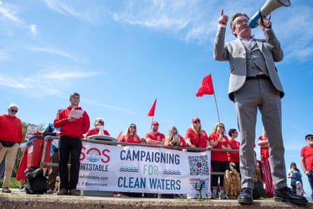 Feargal Sharkey campaigns for clean water with other people dressed in red