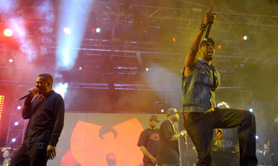 Members of the Wu-Tang Clan perform in front of their band logo in Indio, California, on 21 April 2013. 
