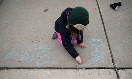 Molly Maguire, 8, uses chalk to calculate an addition problem in her driveway. At least 55.1 million students have been impacted by school closures during the pandemic.