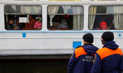 Civilians evacuated from the Russian-controlled city of Kherson arrive by ferry in the town of Oleshky, Kherson region