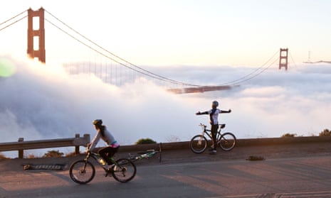 Cyclists overlooking the Golden Gate Bridge in the fog