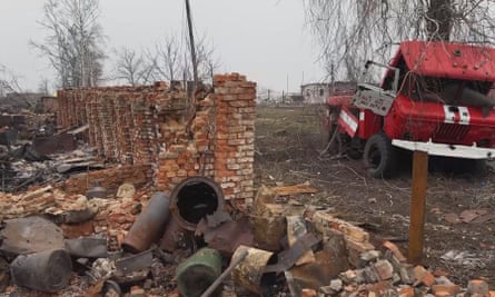 A destroyed building and damaged vehicle at a settlement recaptured by Russian forces in the Kursk region of Russia.