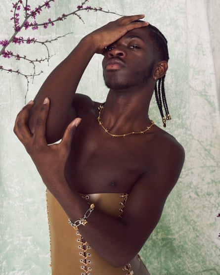 Lil Nas X wearing a gold corset and a necklace