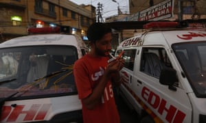 Safdar lights a cigarette during a moment of downtime
