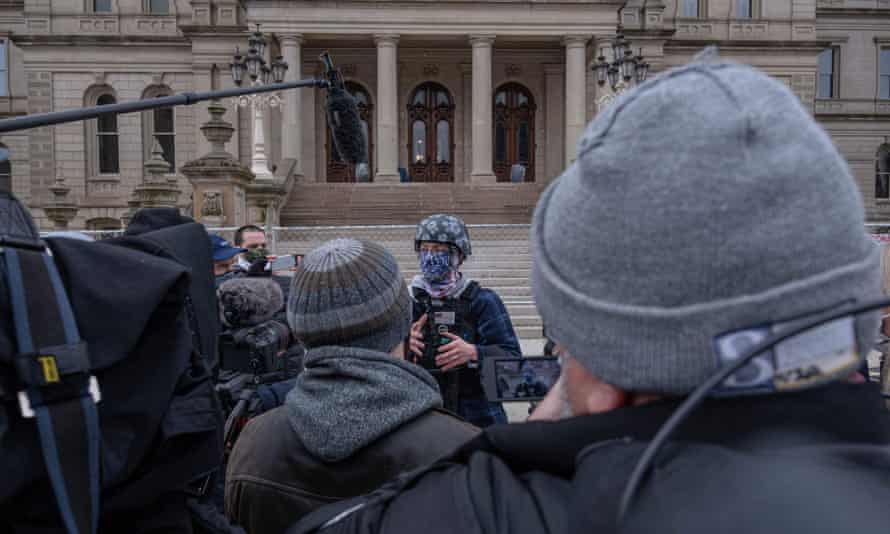 A member of the Boogaloo Bois, an anti-government group, spoke to the press on Sunday in front of the Capitol building in Lansing, Michigan.