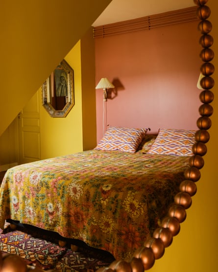 The ‘homely, vintage vibe’ of the bedroom, with Les Causeuses mirror and floral bedding.