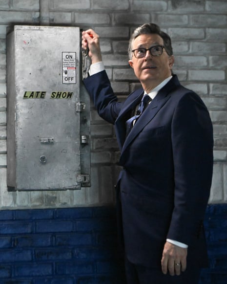 man in suit looks up and pulls electrical lever marked 'late show'