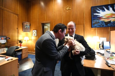 Jared Polis, right, and first gentleman Marlon Reis talk in the govenor’s suite with their dog Gia.