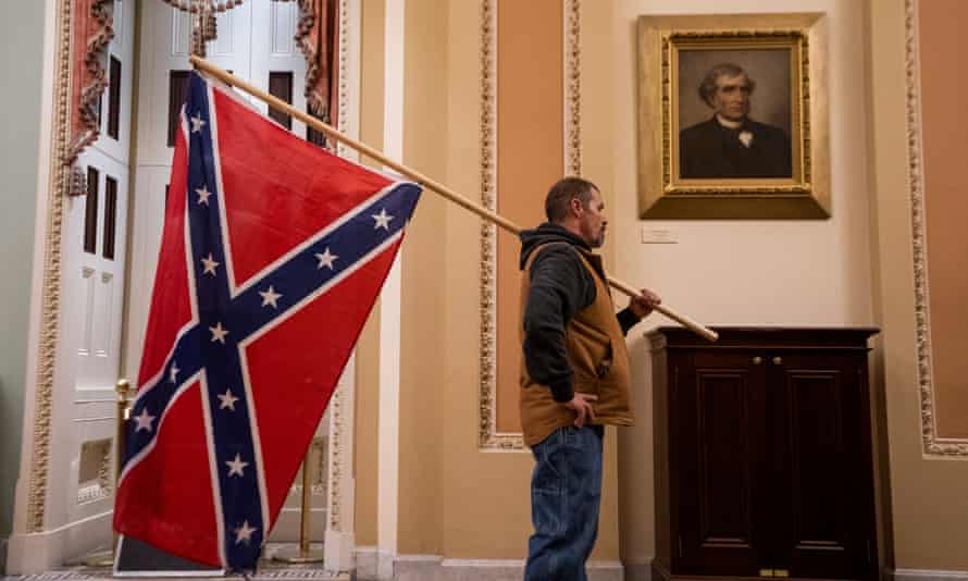 A protester carrying a Confederate flag inside the Capitol.