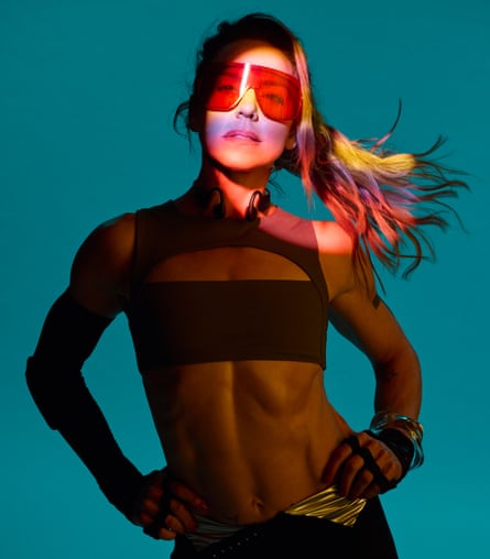 Melanie C wearing a red visor and a see-through black top, with a long ponytail