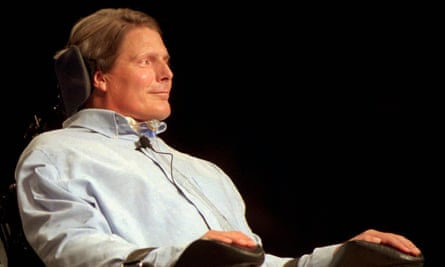 Man wearing blue buttondown sits in wheelchair.