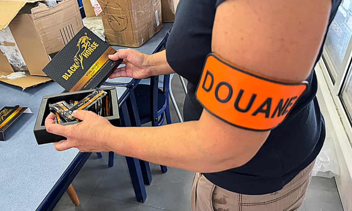 A French customs officer with packs of illegally imported ‘aphrodisiac’ honey