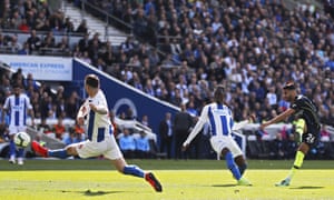 Manchester City’s Riyad Mahrez scores his side’s third against Brighton.