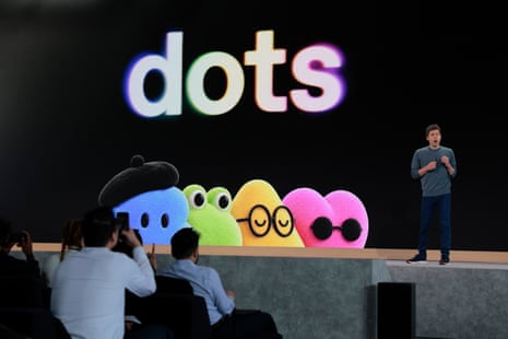 Sam Altman speaks on stage beside colourful fuzzy characters under a large "dots" logo