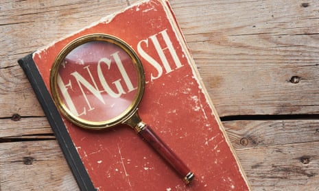 Book saying 'english' and magnifying glass on a wooden desk