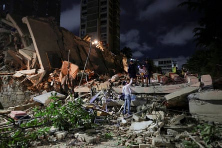 Emergency services work at the site of a collapsed building in Caracas.