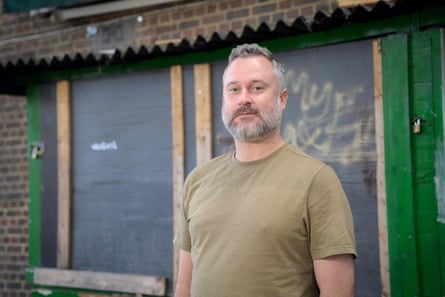 Lewis Galloway standing by padlocked sheds