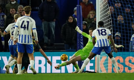 The Everton goalkeeper, Jordan Pickford, makes a save during the Premier League match against Brighton.